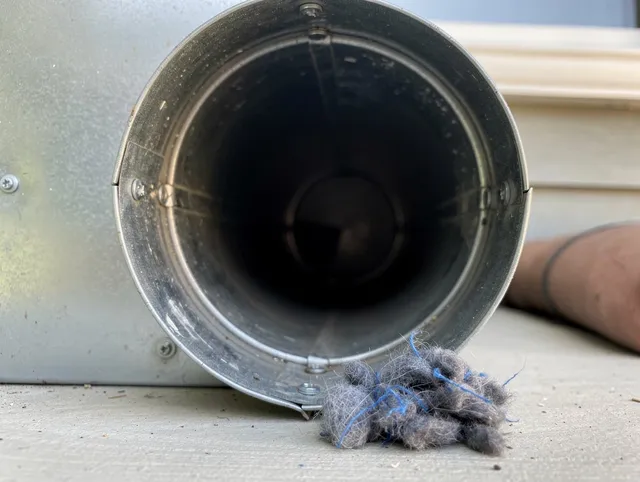 Medway Dryer Vent Cleaning technician using specialized equipment to clear severe dryer vent blockage in Medway